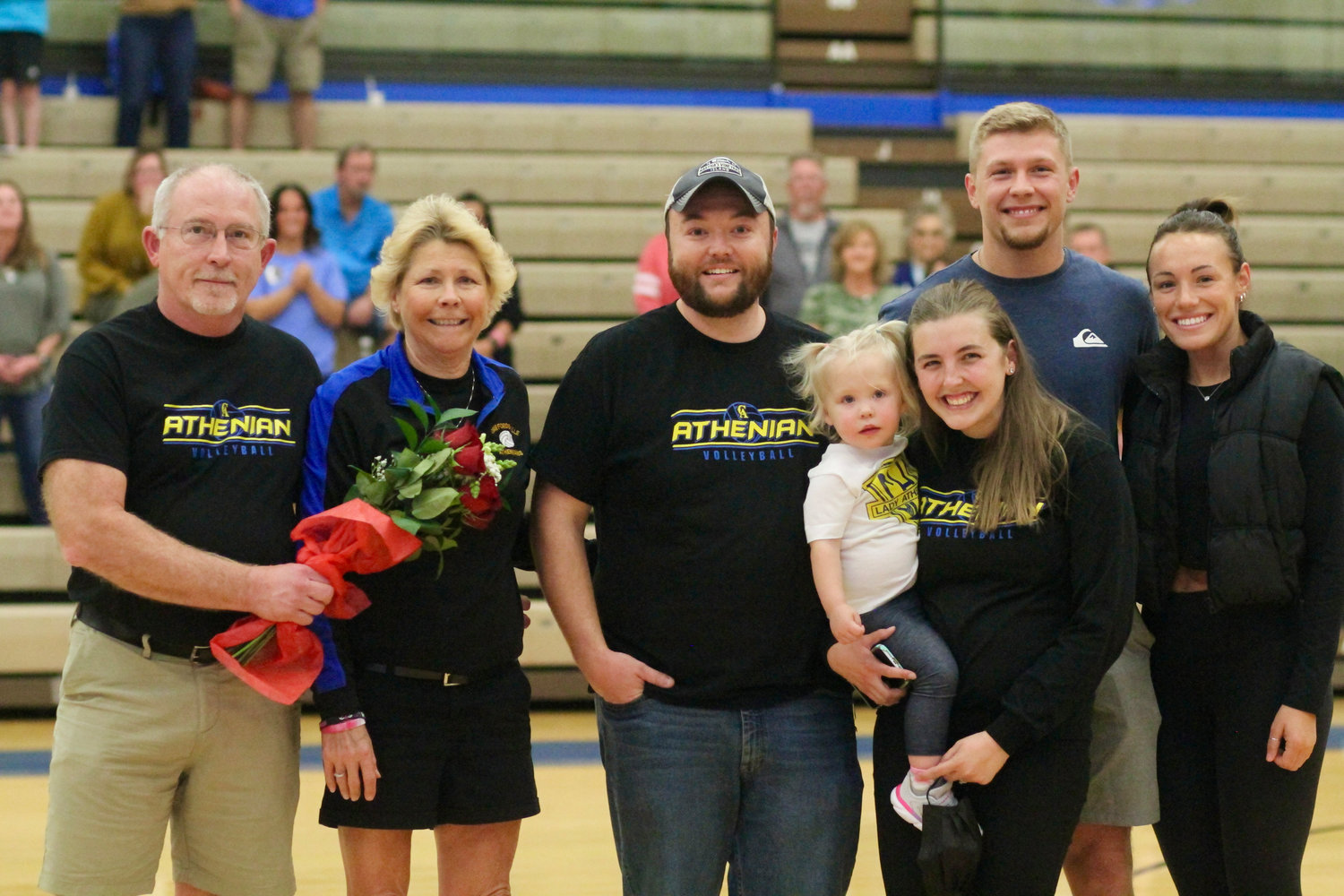 Crawfordsville volleyball coach Kelly Johnson is joined by her family at center court as she’s honored for her 39 years of dedication and service to the Athenian program.