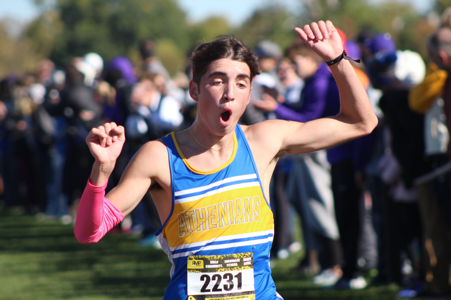 Crawfordsville’s Ryan Miller reacts to breaking the school record as he crosses the finish line at the Brownsburg sectional.