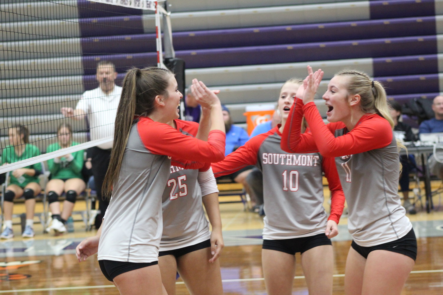Southmont’s Chelsea Veatch, Mallory Mason (11), and DeLorean Mason (10) celebrate Veatch’s kill during their 3-0 sweep of Cloverdale in their sectional opener on Tuesday.