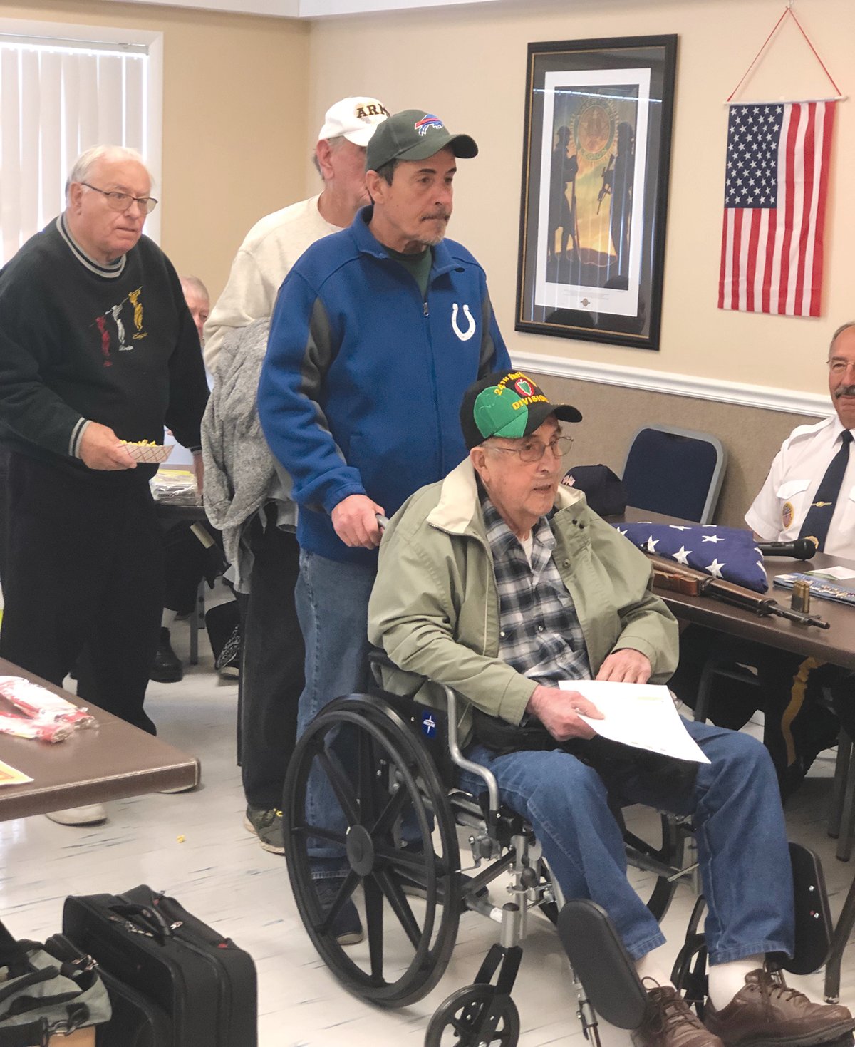 Veterans line up for a free book Thursday during the annual Veterans Expo at the Byron Cox American Legion Post 72.