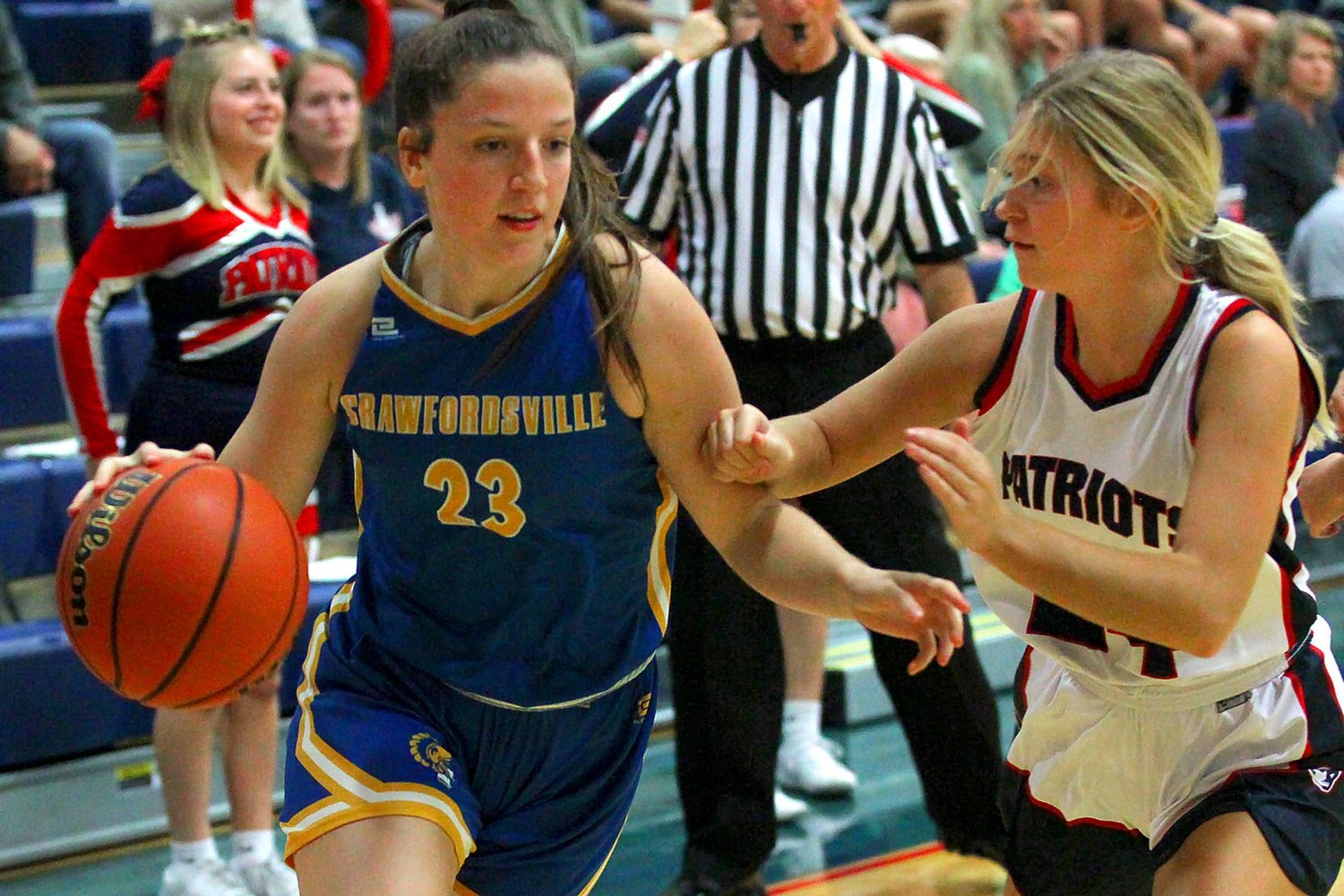 Taylor Abston of Crawfordsville keeps Rylea Wetz of Seeger at a distance on a drive to the basket. Abston ended the game with 15 points to lead CHS.