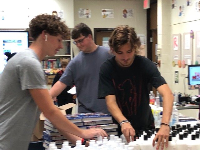 Sam Line, Gabe Little and Ryley Mitton set up an assembly line for FCCLA members.