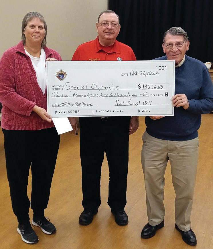 Pictured, from left, are Michelle Goodin receiving check from Bernie Williams Grand Knight and Jim Gineris 2022 K of C Tootsie Roll Drive Chairman.