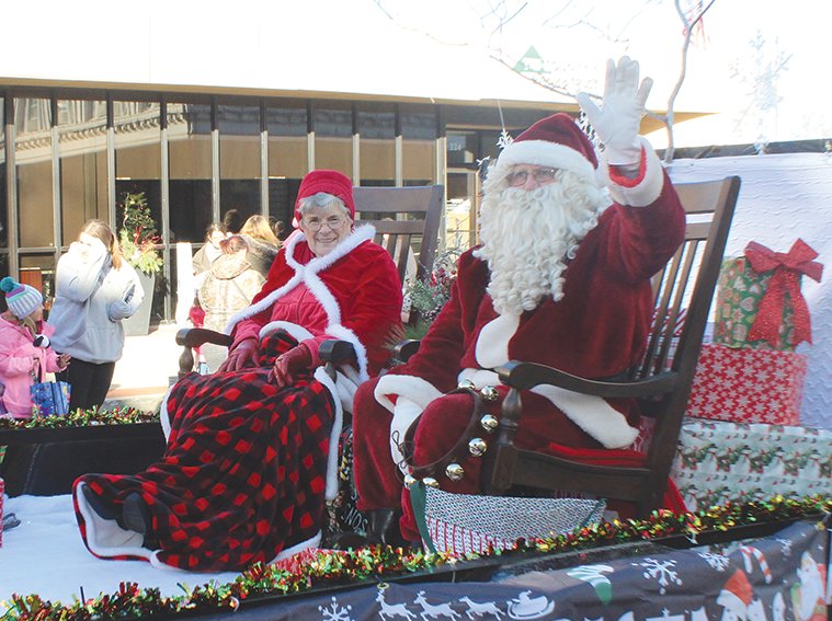Santa and Mrs. Claus wave to the crowds at the 2022 Downtown Christmas Parade.