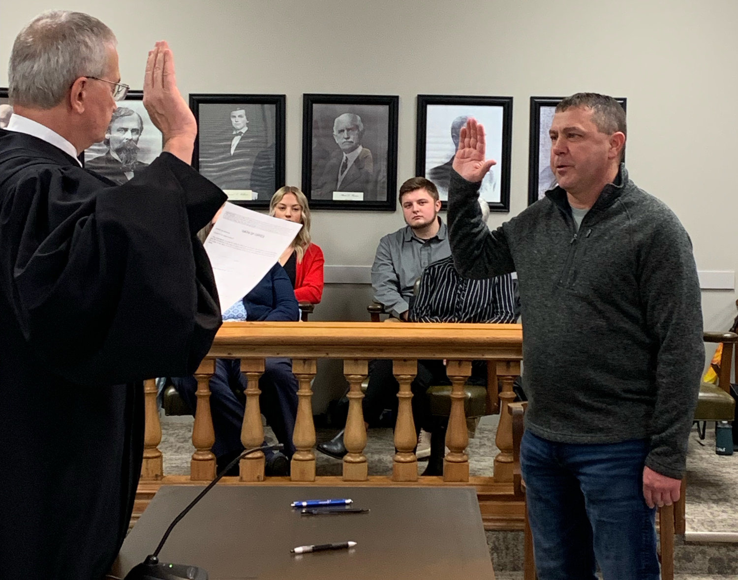 Jim Fulwider, an incumbent district 2 commissioner, takes another oath of office.