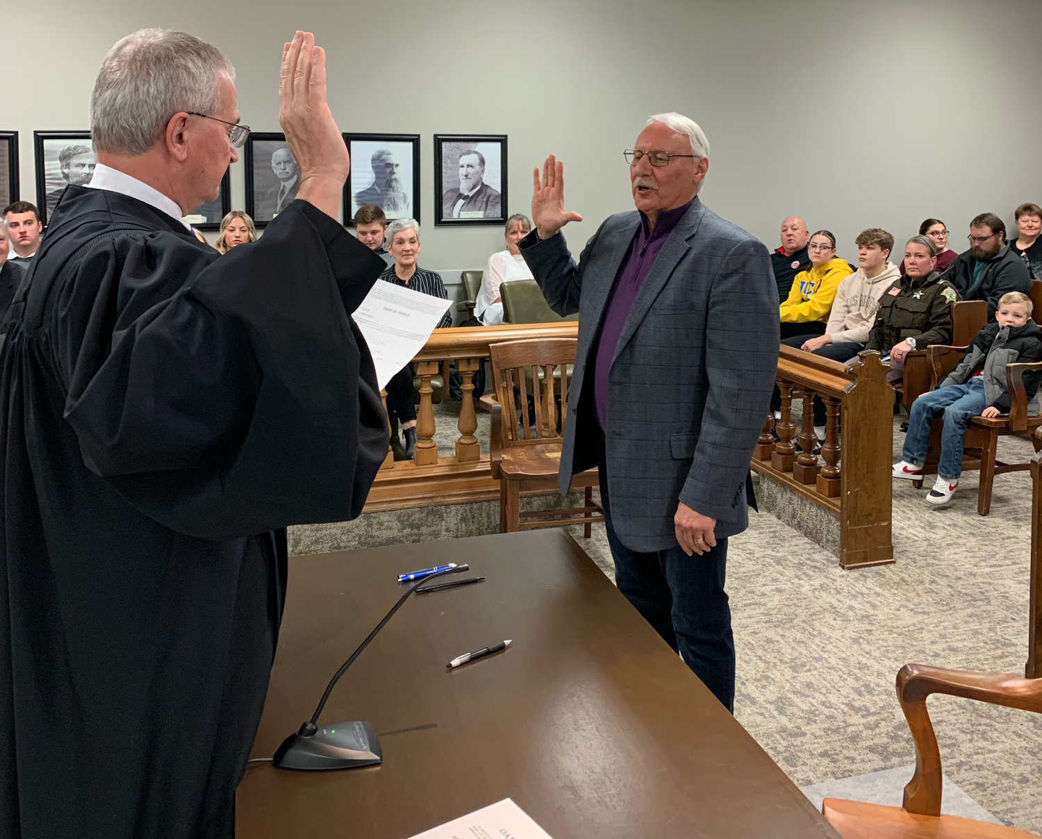 Retiring Montgomery Circuit Court Judge Harry Siamas, left, conducts the oath of office to Steve Loy, a new district 3 councilman.