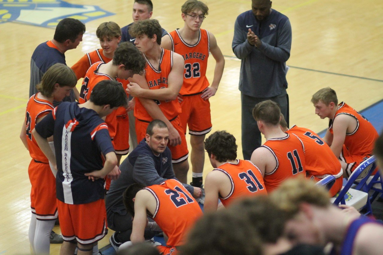 Charger coach Chad Arnold giving instructions to his team during a timeout.