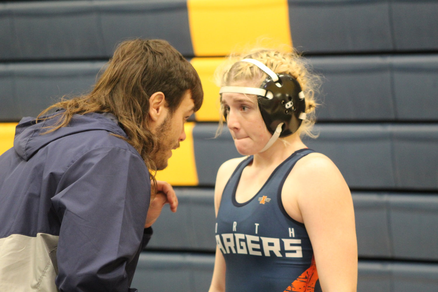 Charger assistant coach Trizton Carson gives Moffit a pep talk before her match.