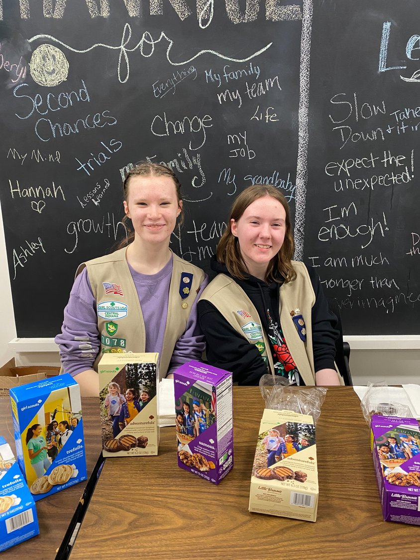 Scouts Hope Taylor and Elizabeth Dodd pass out cookies for taste test.