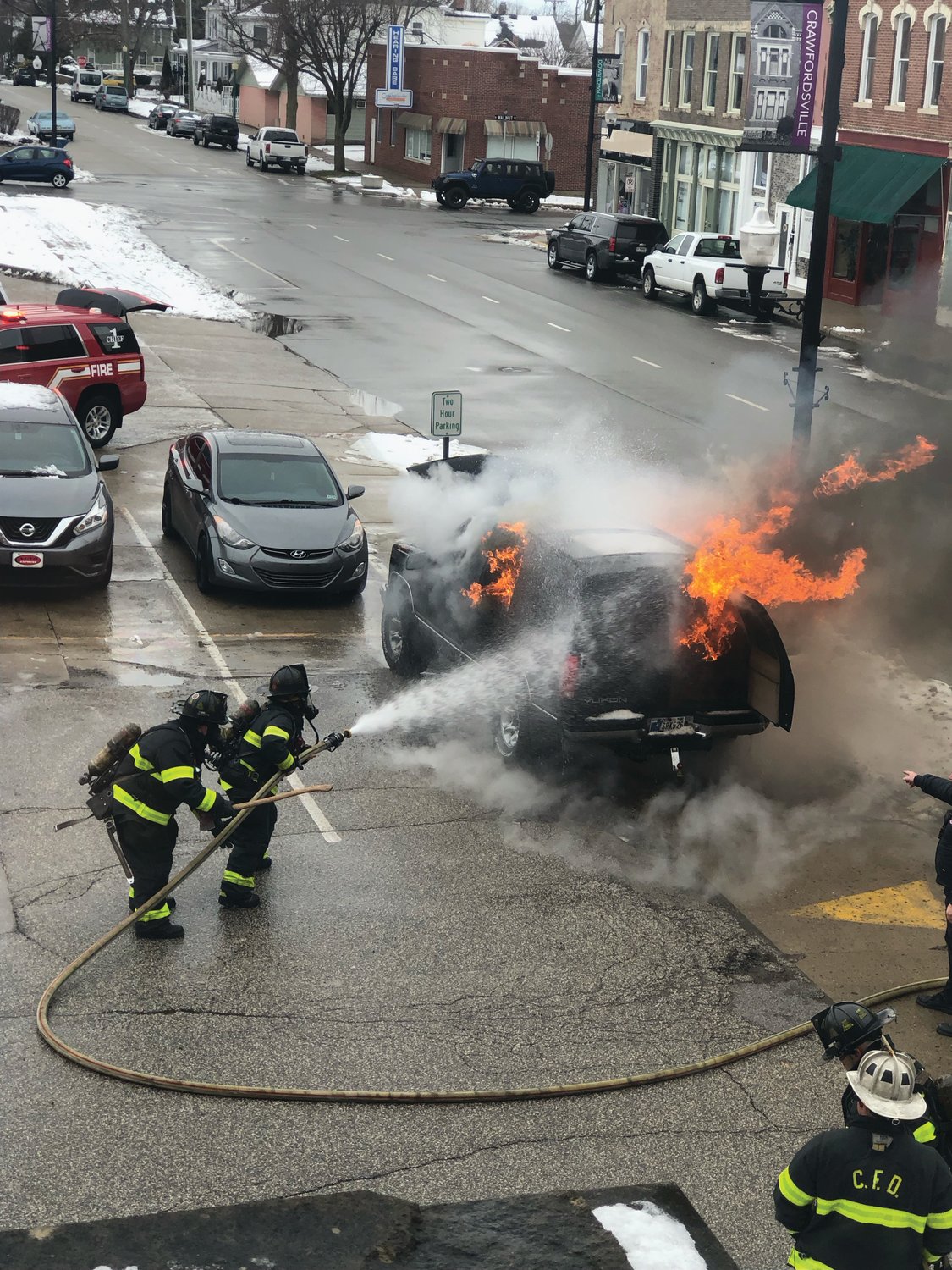Members of the Crawfordsville Fire Department extinguish a car fire at 3 p.m. Friday behind the Fusion 54 building in the 100 block of West Main Street. No injuries were reported and no other property was damaged.