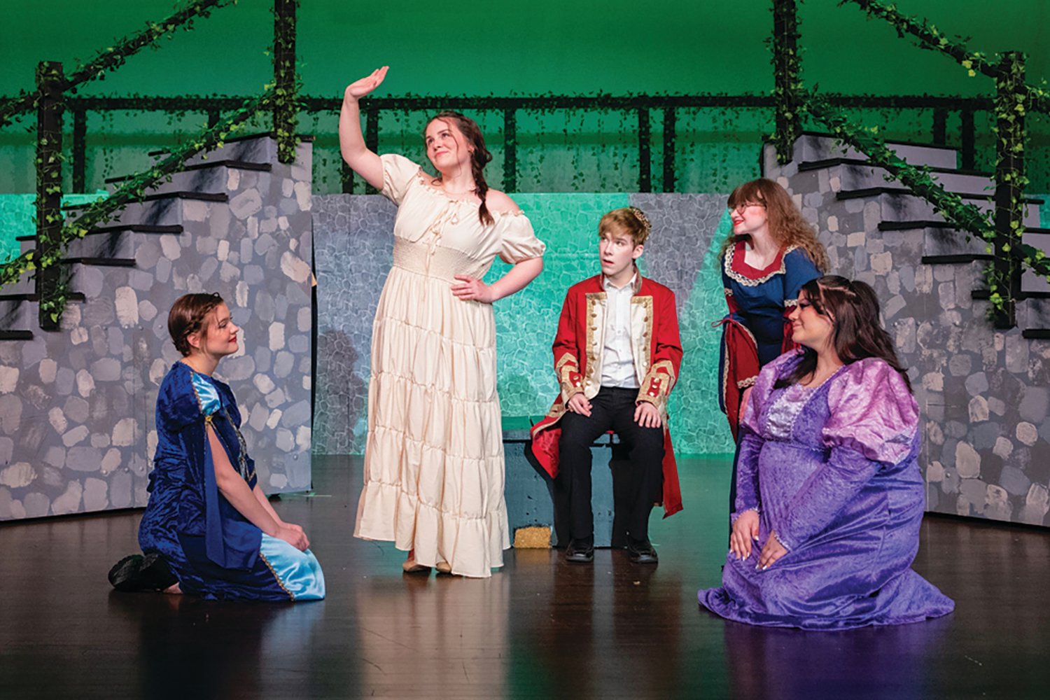 Emerson Boaz, who plays Winifred, left, and Rylan Dowell, who plays Prince Dauntless, center, rehearse a scene from Once Upon a Mattress with ladies in waiting, Aurora Murdock, Shelby Kamerer and Kennedy Isbell.