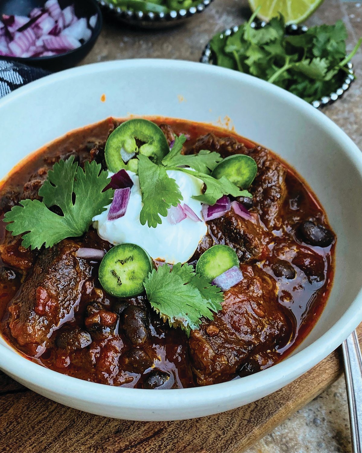 When you make this rich and meaty black bean stew, you will be rewarded with a comforting, deeply flavored chili, tinged with smoke and fragrant with spice.