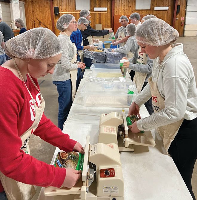 Montgomery County Junior Leaders worked to fill, weigh, seal and pack meals that would benefit families in the county.