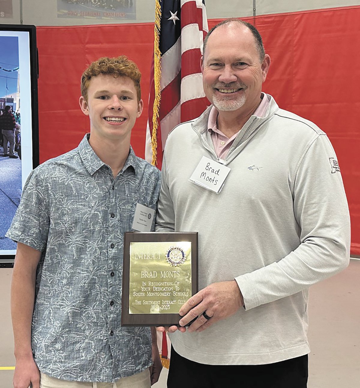 Brad Monts, president and CEO of Hoosier Heartland State Bank, accepts a plaque from Interact Club member Hayden Hess.