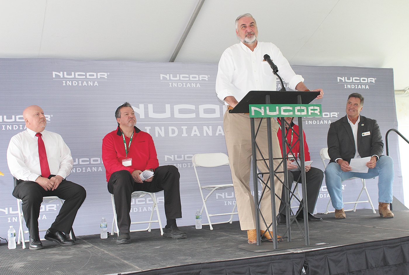 Indiana Gov. Eric Holcomb speaks to a large crowd of Nucor teammates, other state and local officials and community members who gathered for the event.