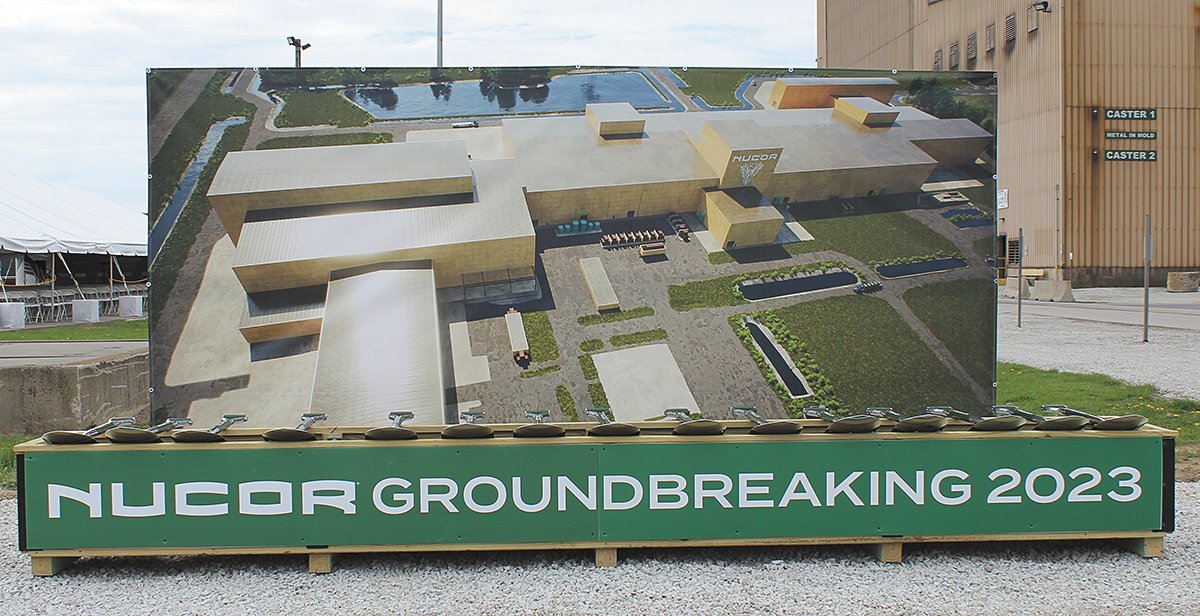 A large photo illustration of the new complex was used Friday as a backdrop to the ceremonial groundbreaking ceremony at Nucor.