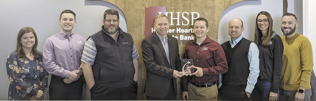 Displaying HHSB’s Five Star Member award from the Indiana Bankers Association are, from left, Lana Buck, Adam Bonebrake, Ray Claycomb, Rod Lasley (IBA Chief Operating Officer), Zach Hockersmith, Blake Zachary, Caryn Heisel and Cody Hargis.