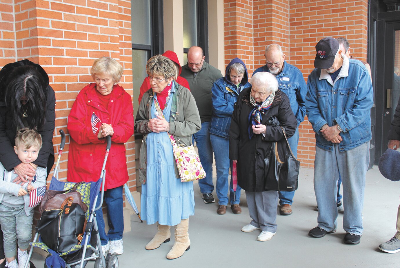 A group of devoted Christians bow their heads during one of the many prayers spoken aloud on the courthouse patio during the 2022 National Day of Prayer.