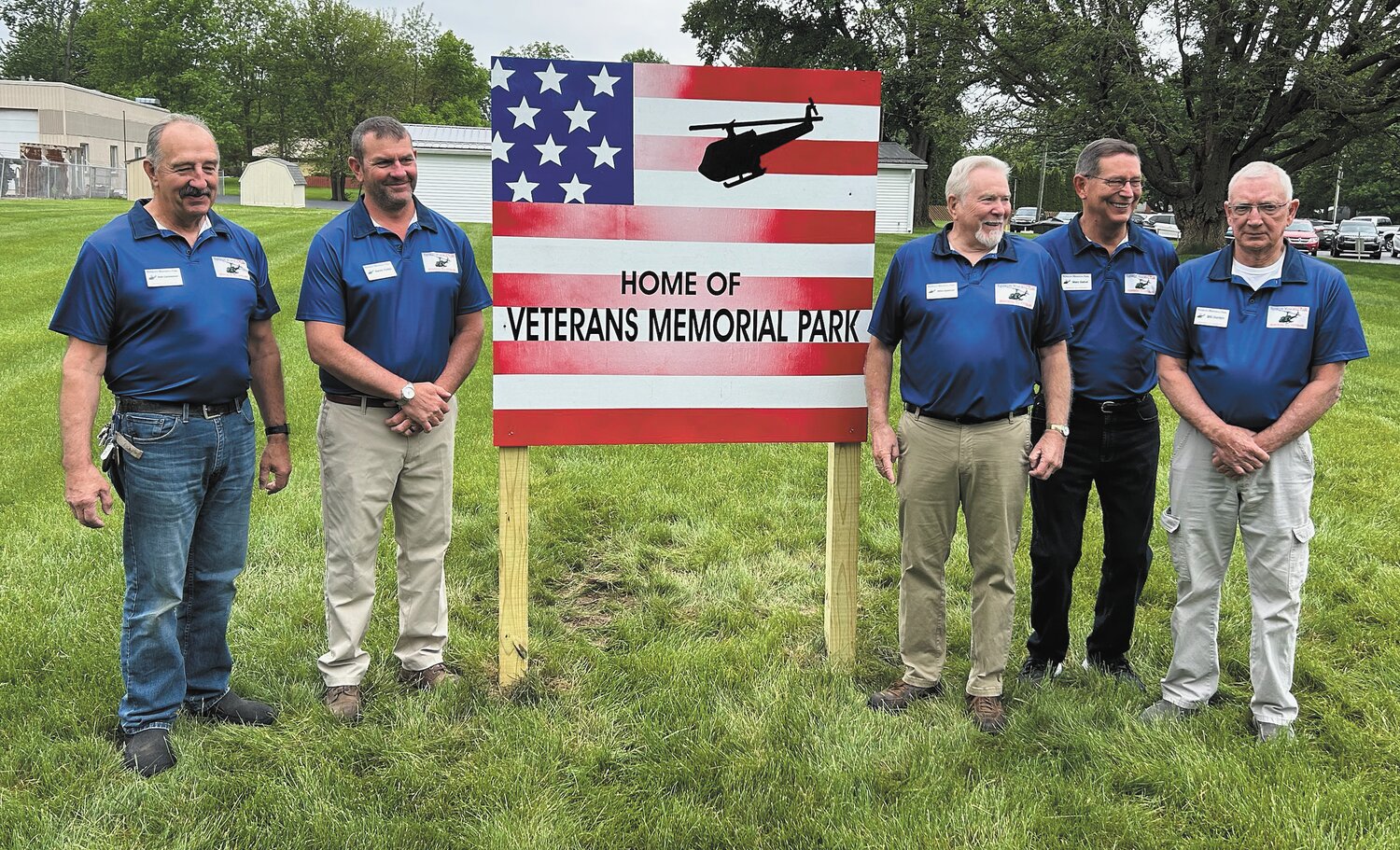 Five of the six Veterans Memorial Park board members gather Monday for a photo announcing the creation of the new park.