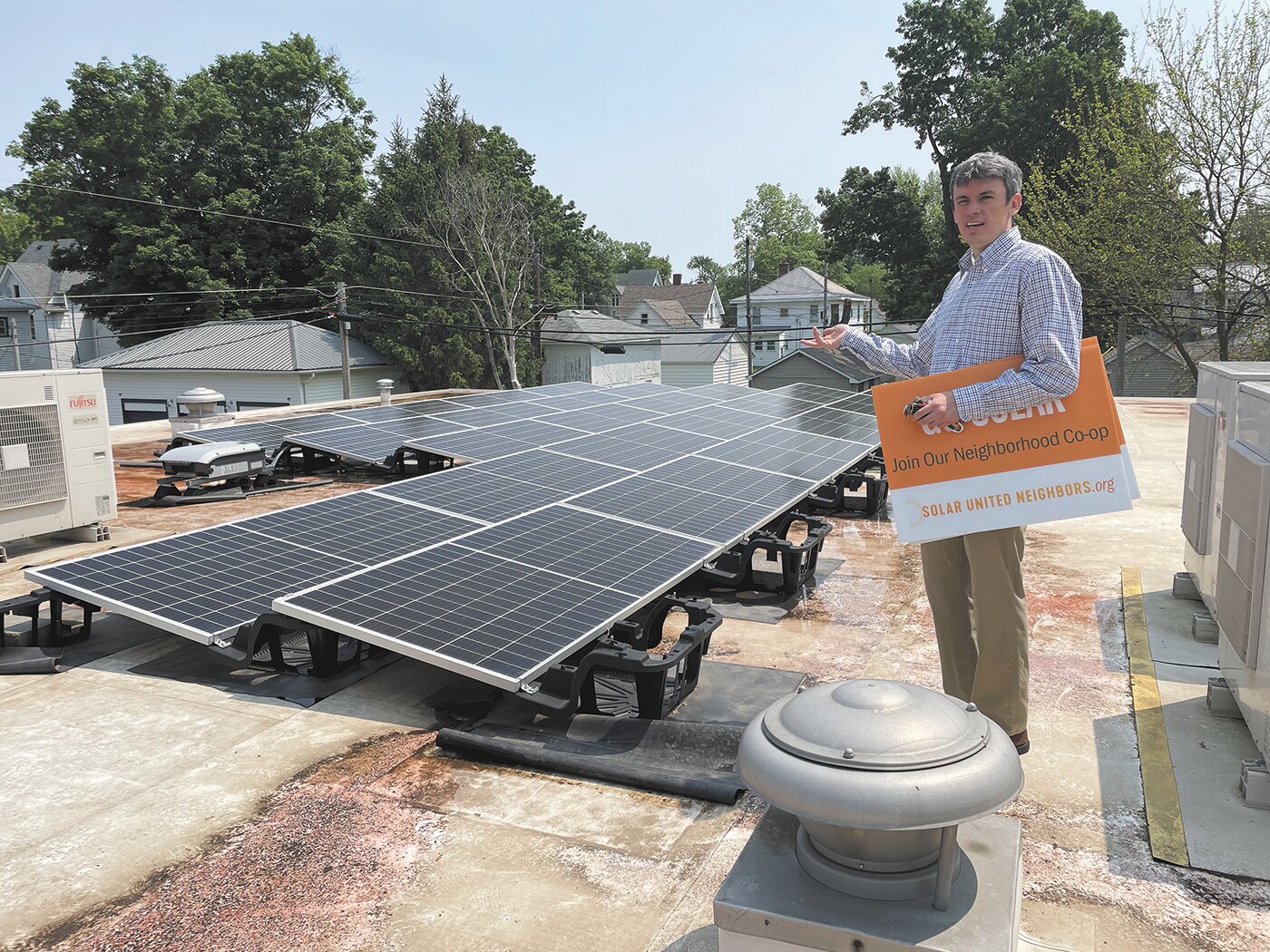John Smillie discusses the benefits of solar energy from atop the Montgomery County Youth Service Bureau building at 808 W. Pike St. Local officials and community members gathered at the facility Wednesday to launch Solar United Neighbors, a solar energy cooperative.