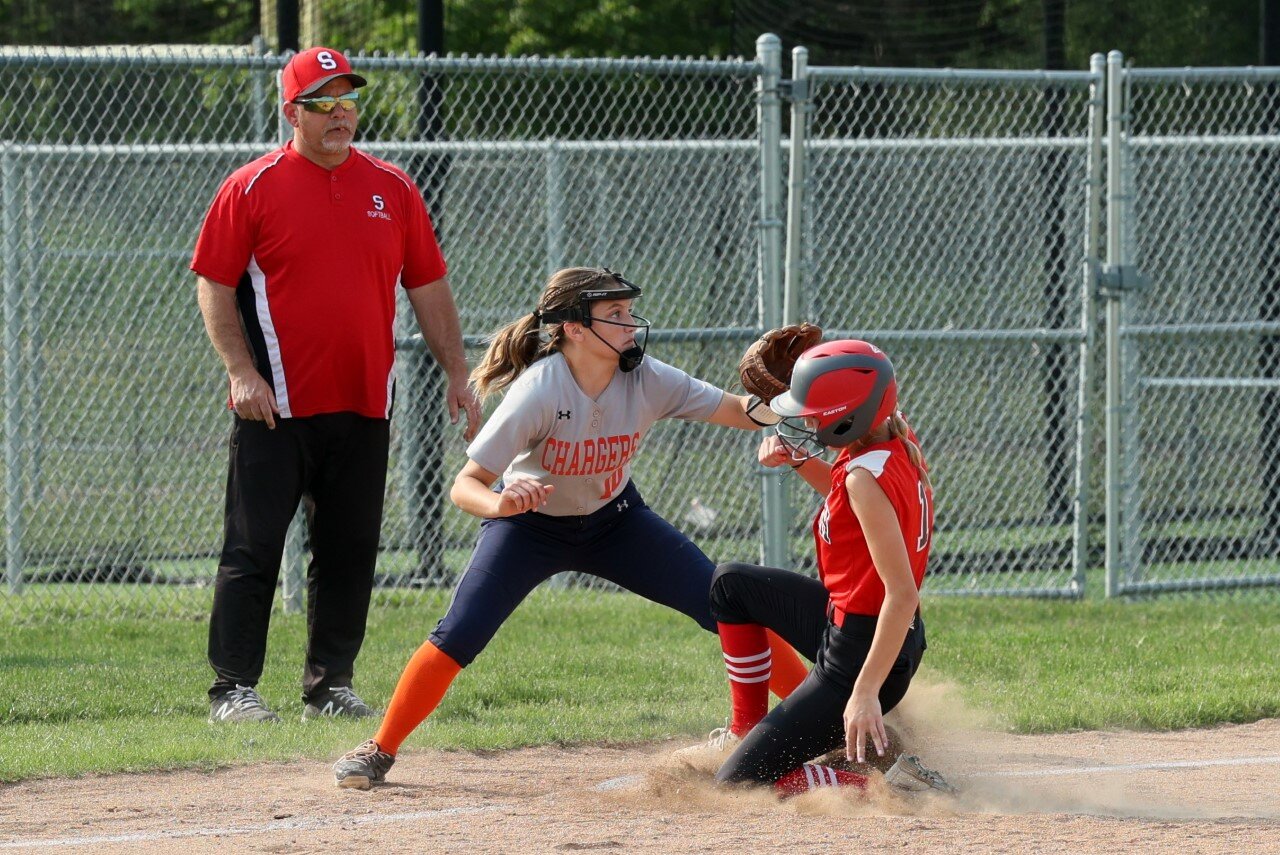 Charger freshman Sophia Shea fields third as she tries to tag out a Mountie base runner.