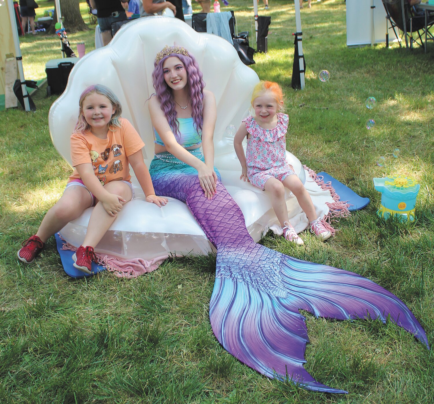 Sawyer Ranspach, 7, left, and Parker Ranspach, 4, pose with a mermaid in the Children's Area.