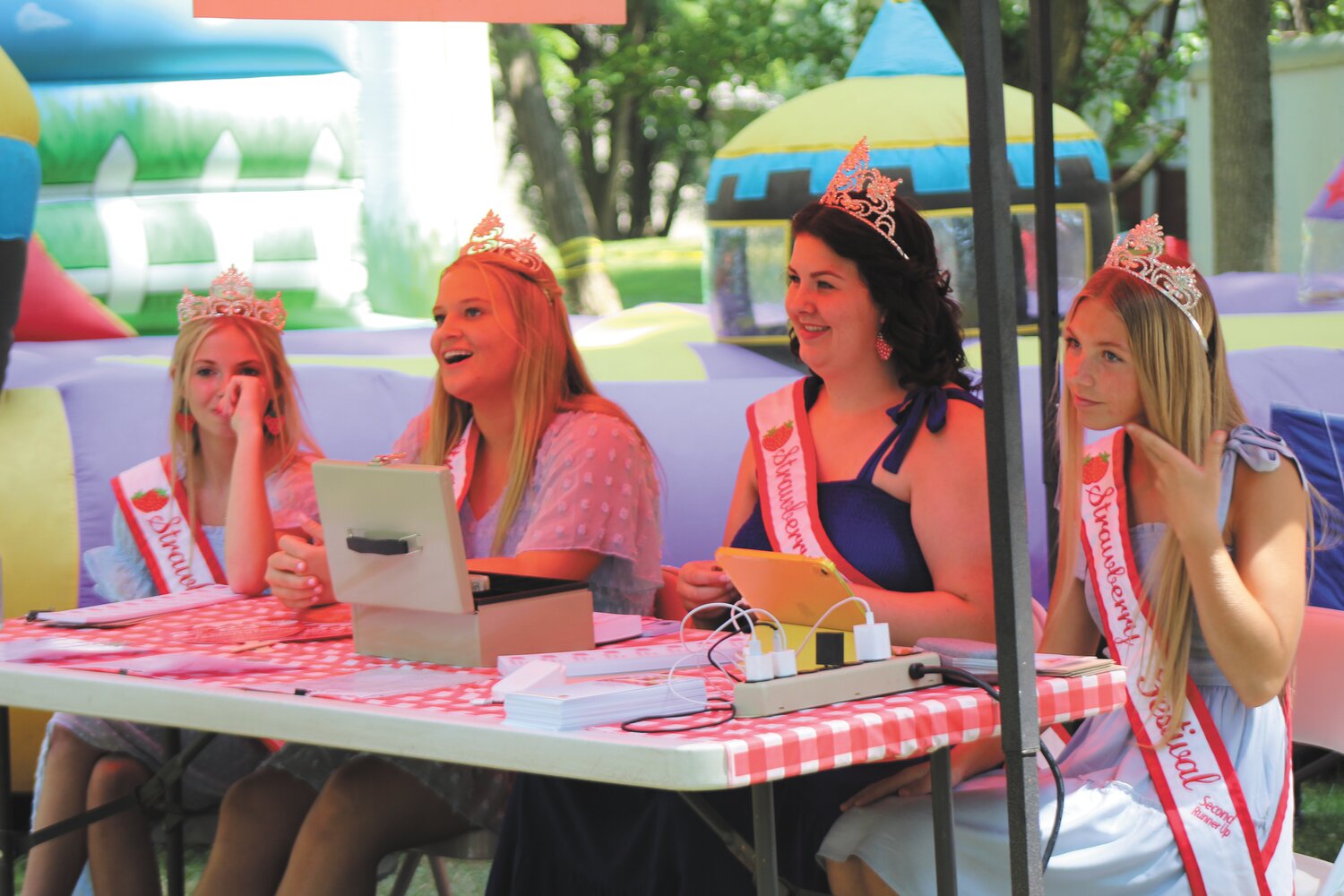 Strawberry Festival royalty sell tickets in the Children's Area.