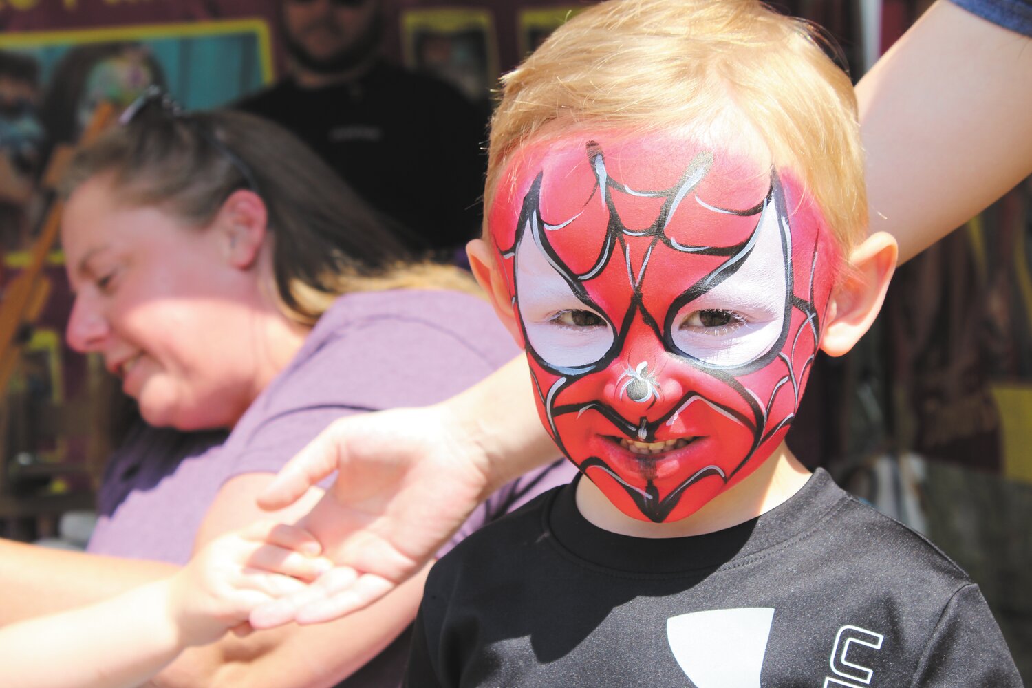 Waylon Oliver, 3, was all smiles after having his face painted to look like Spiderman.