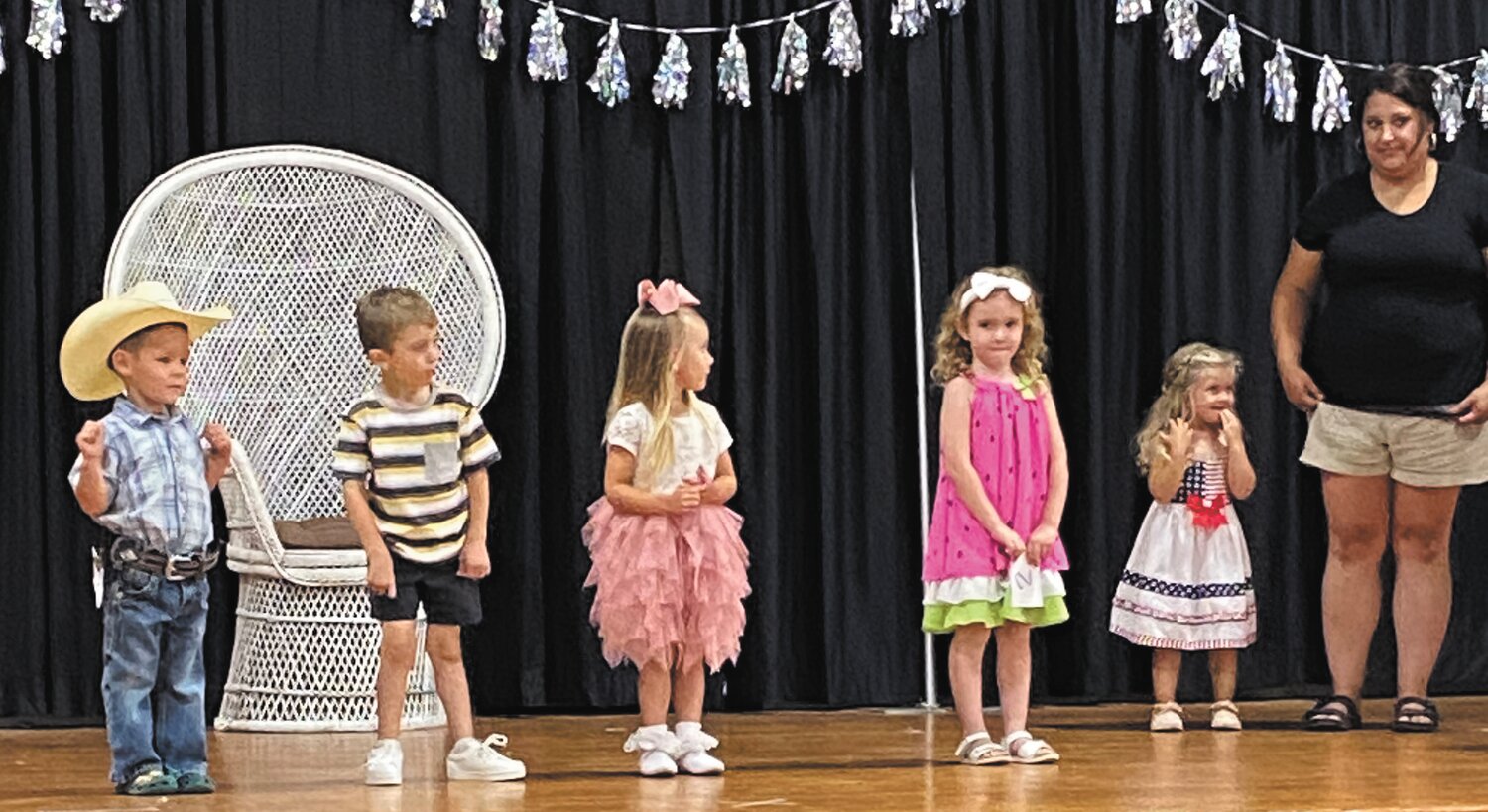 Contestants in the Junior Miss and Mister Division, ages 3-4, line the stage.