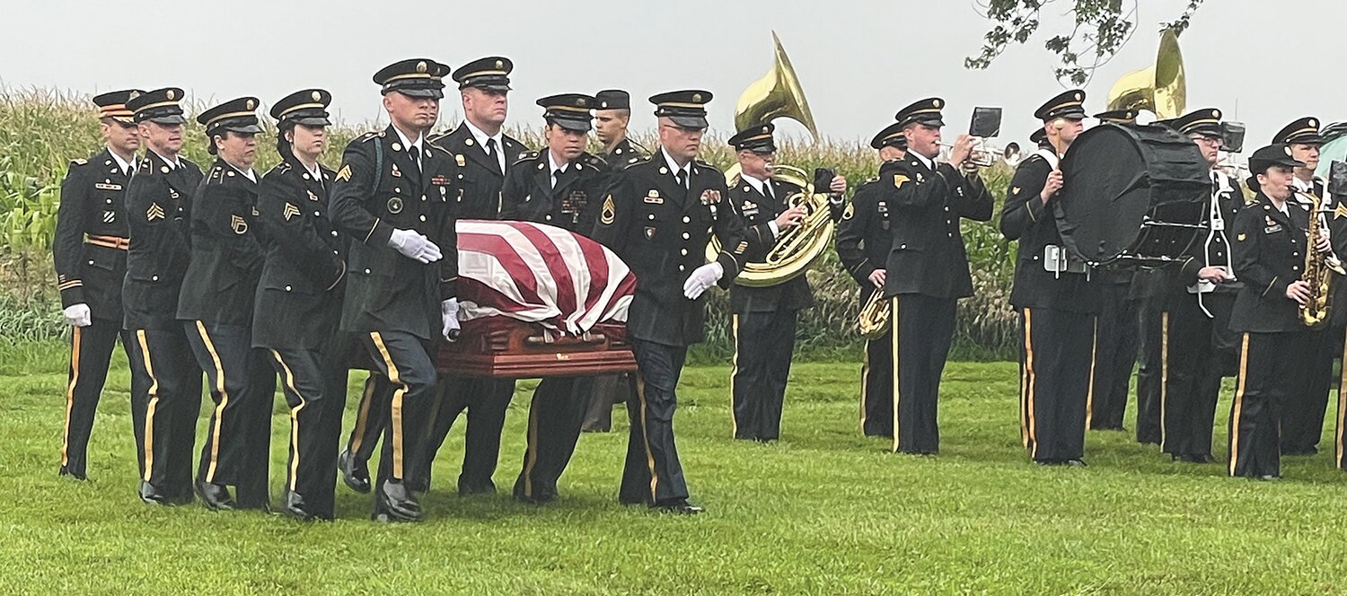 The casket is carried from the caisson to the gravesite.