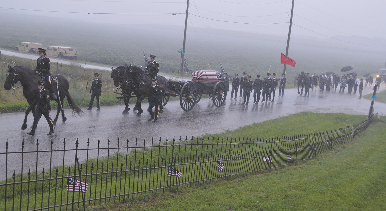 A caisson carries Richard "Dick" Chastain to his final resting place at Oakland Cemetery north of Elmdale. Members of Chastain's family walked behind the horse-drawn wagon.