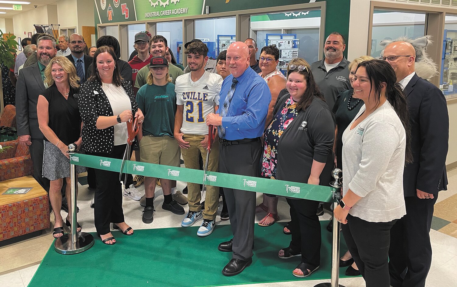 Crawfordsville Mayor Todd Barton and West Central CTE Director Sara Nicodemus, prepare to cut the ceremonial ribbon for the launch of the Indiana Career Academy at Ivy Tech Community College, Crawfordsville.