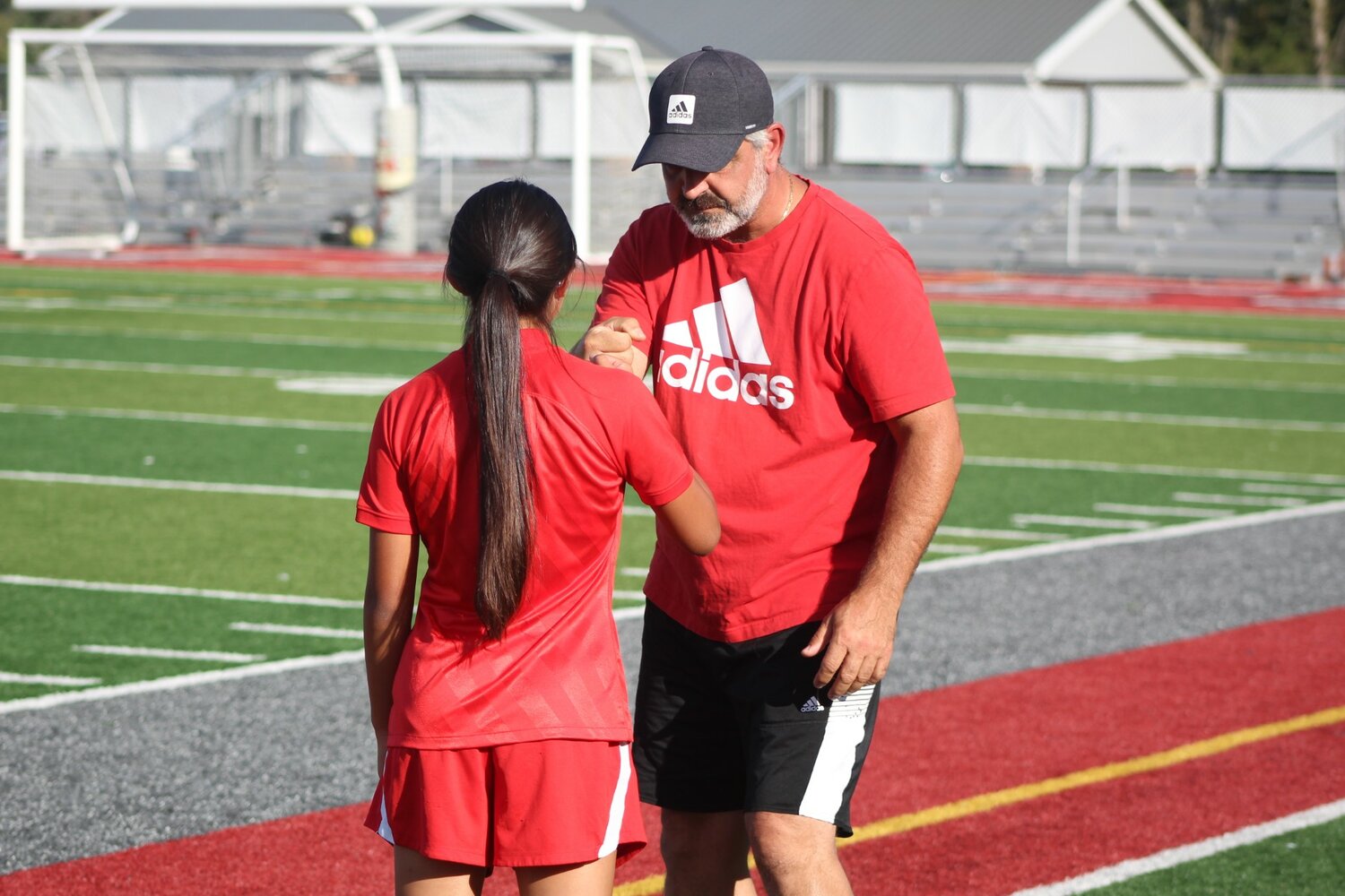 South coach Roger Azar gives a fist bump to freshman ZuZU Trautwein after she subbed out of the game.