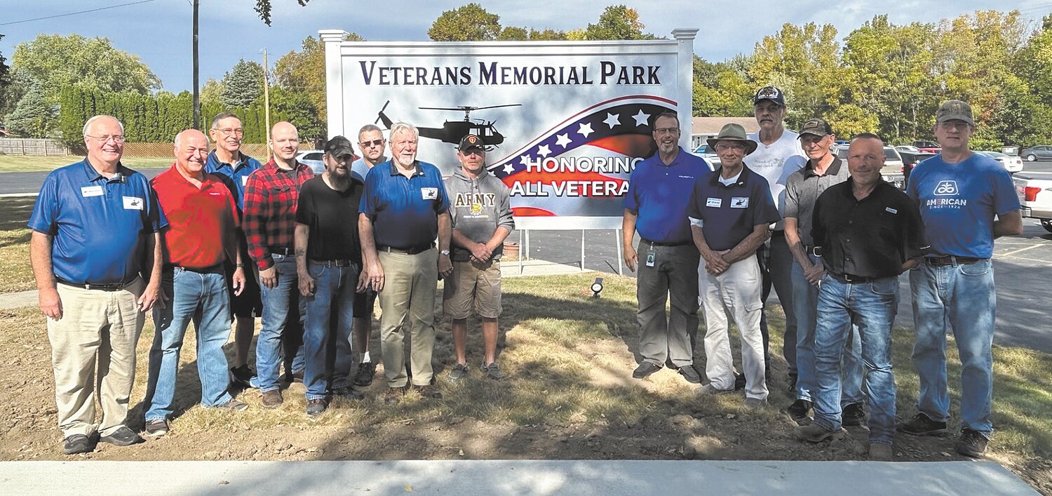Acuity Lighting employees, veterans and Veterans Memorial Park board members gathered Tuesday to celebrate a donation of lighting for the newly-formed park on South Washington Street adjacent to the American Legion Post.