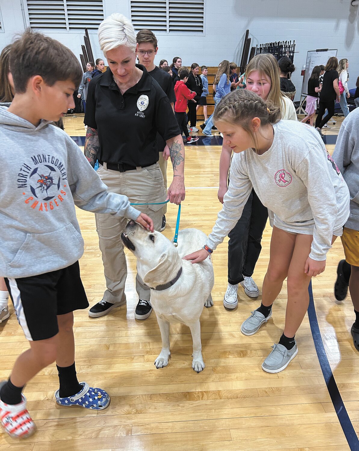 Shannon Taylor, center, is a digital forensics investigator for the Tippecanoe County Prosecutor’s Office. She talked Friday to North Montgomery Middle School students about online dangers. Taylor also brought along her K9 partner Roger.