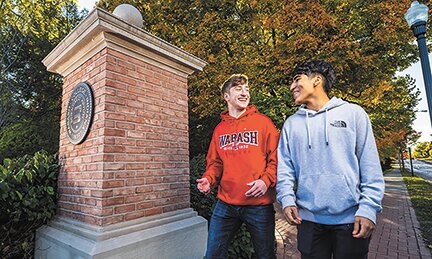 Two Wabash College students walk on campus near the gateway entrance. Wabash graduates continue to land some of the best salaries nationally when it comes to early- and mid-career earnings.