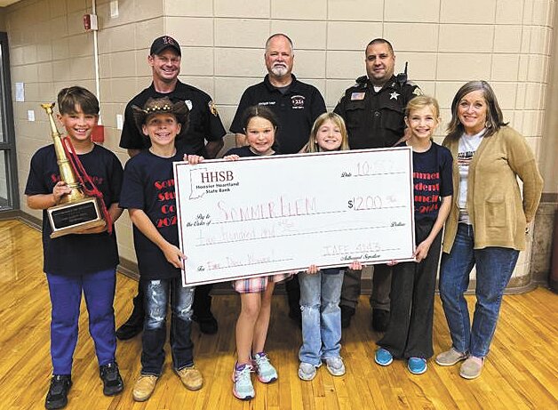 Pictured are Sommer Elementary Student Council Representatives, Sommer Elementary Principal Suzi Gephart, Andrew Traylor, Division Chief Brian Bechtel and School Resource Officer A.J. Rice.