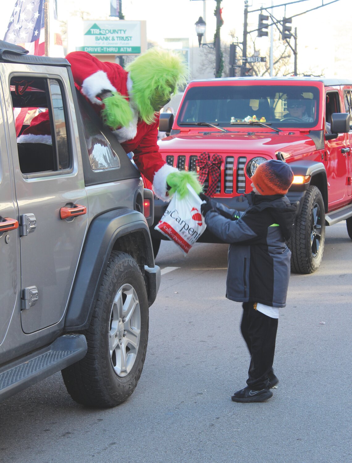 The Grinch makes a grab at a boy’s candy bag, but was unsuccessful in snatching the treats.