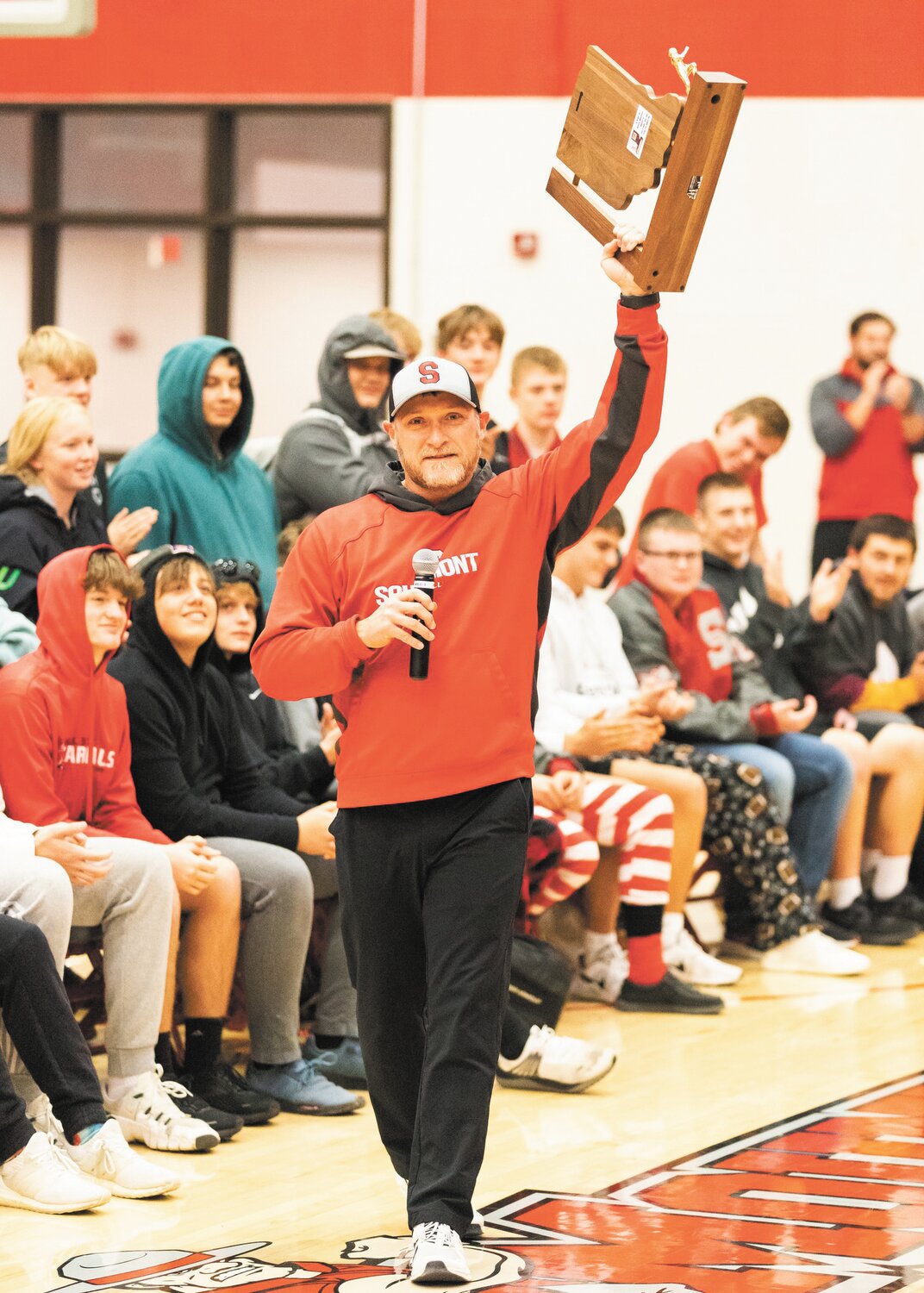 Southmont football coach Desson Hannum addresses the Mountie crowd at the schools pep session last Friday after the Mounties captures the schools first sectional title.