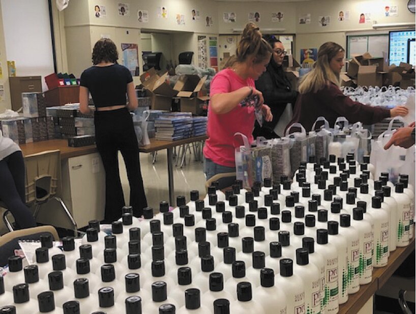 Southmont FCCLA members create toiletry kits in an assembly line fashion..
