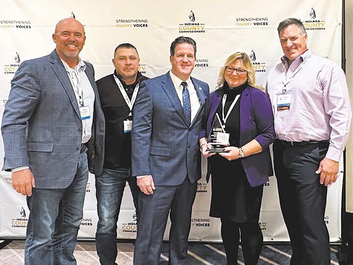 Lori Dossett, second from right, poses with Montgomery County Commissioners Dan Guard and Jim Fulwider, president of Indiana County Commissioners Mark Heirbrandt, and Montgomery County Commissioner John Frey.
