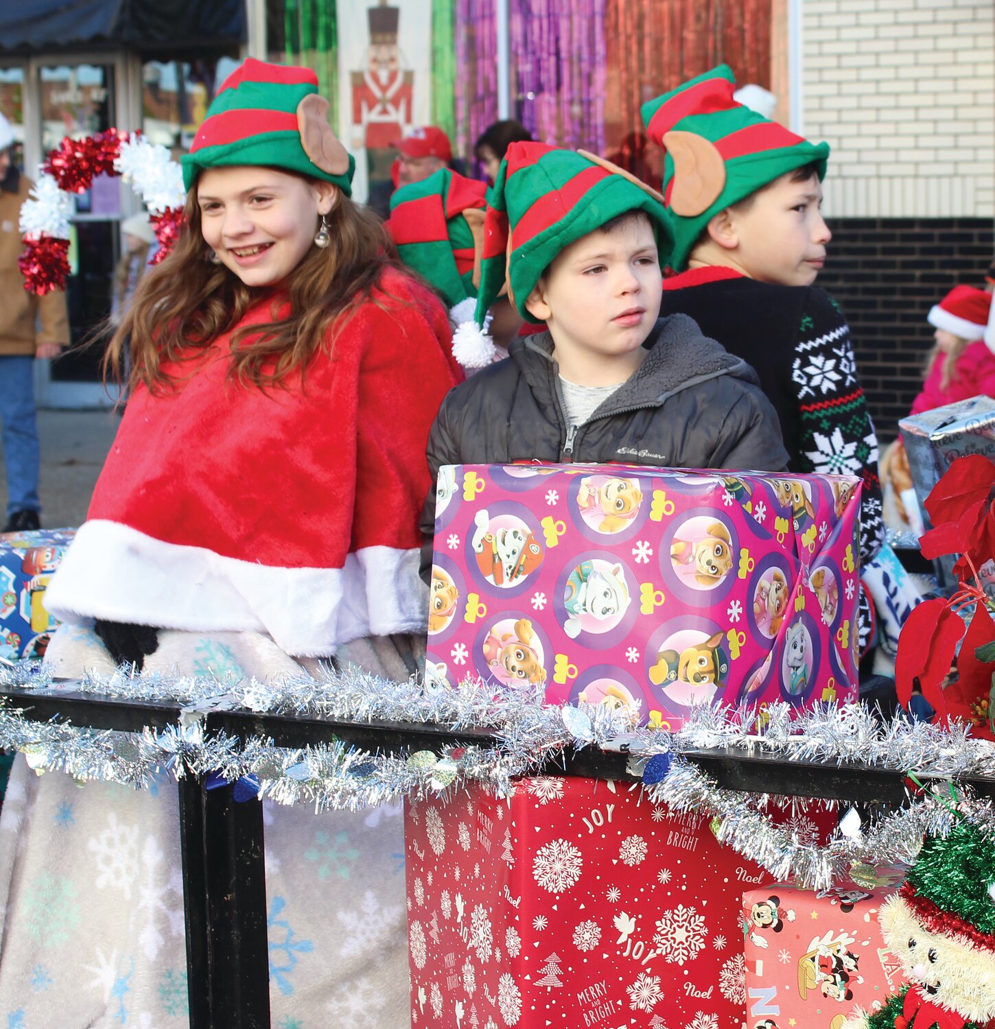 Three little elves spread Christmas cheer during the 2022 Christmas parade in downtown Crawfordsville.