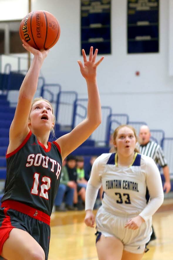 Claire Kessler of Southmont - putting up a lay-up after getting past Katie Brown of Fountain Central