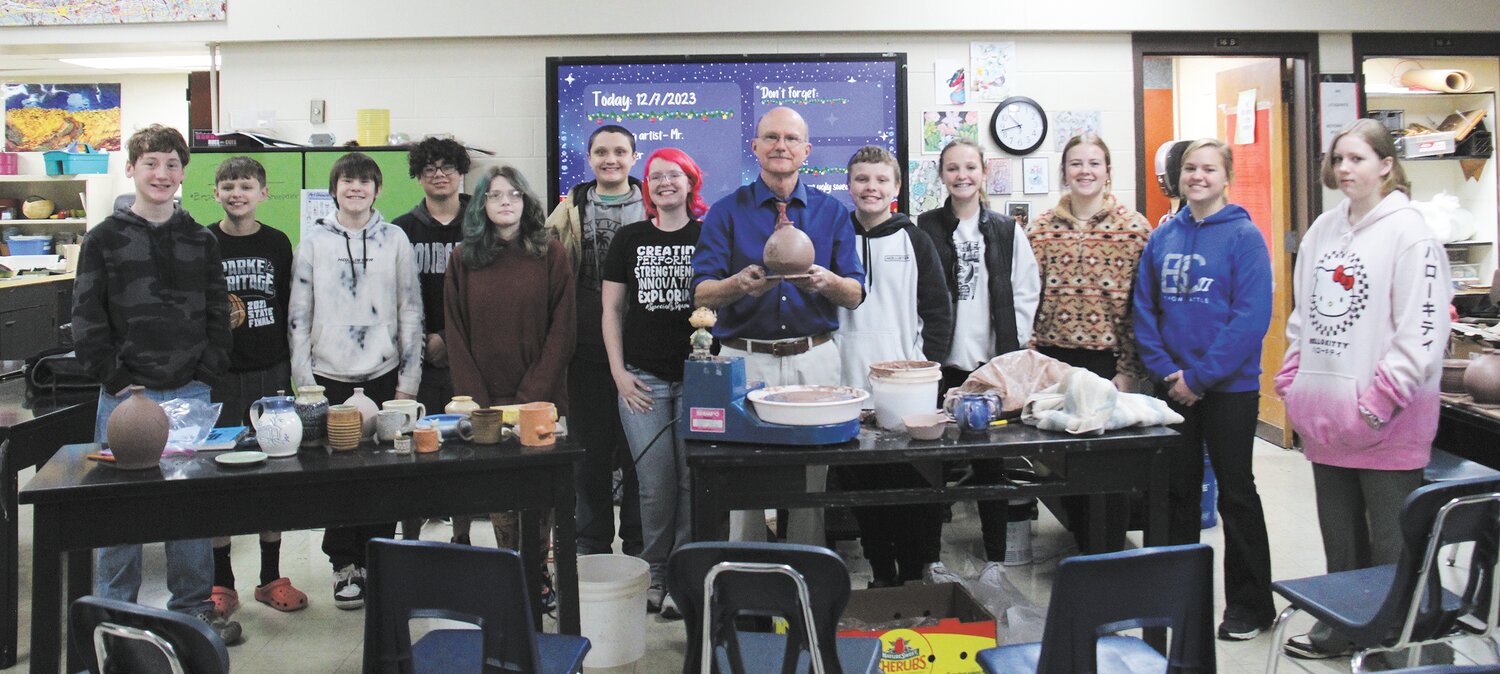 Chuck Wagoner, a retired art teacher from North Vermillion High School, visited the Parke Heritage Middle School art classes Dec. 7 to inspire the young students with his passion for pottery. Wagoner's love for molding and making clay objects started when he was a young child and played in his grandmother's creek. This led to his first official ceramic pot made in art class in 1974 and since then, he has made thousands of pottery items. During his visit, he shared his techniques for making different pots and encouraged the students to experiment with various art forms. Wagoner's love for pottery has not only been a passion but also a means of giving back to the community. He has worked with Catholic Charities to sell soup bowls that have been made by his former students and sold pottery items for Billie Creek and he currently sells items at Bridgeton. He also emphasized the importance of studying different artists to find inspiration and to develop one's own unique style. Through Wagoner's visit, the students gained valuable insights into the world of pottery and the importance of pursuing one's passion. Pictured are Logan White, Jase Bowles, Aiden Nicholas, Chloe Clocksin, Steven Myers, Mrs. De Householder, Chuck Wagoner, Matthew Fox, Alisa McMullen, Kennedy Mitchell, Cohen Berry and Serenity Baumer.