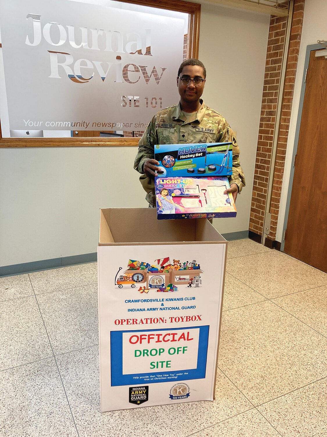 A member of the Indiana National Guard collects donations at the Journal Review for Operation: Toybox. The local newspaper has participated several years as an official drop off site. The annual toy drive organized by the Kiwanis Club helps give local children have a merry Christmas.