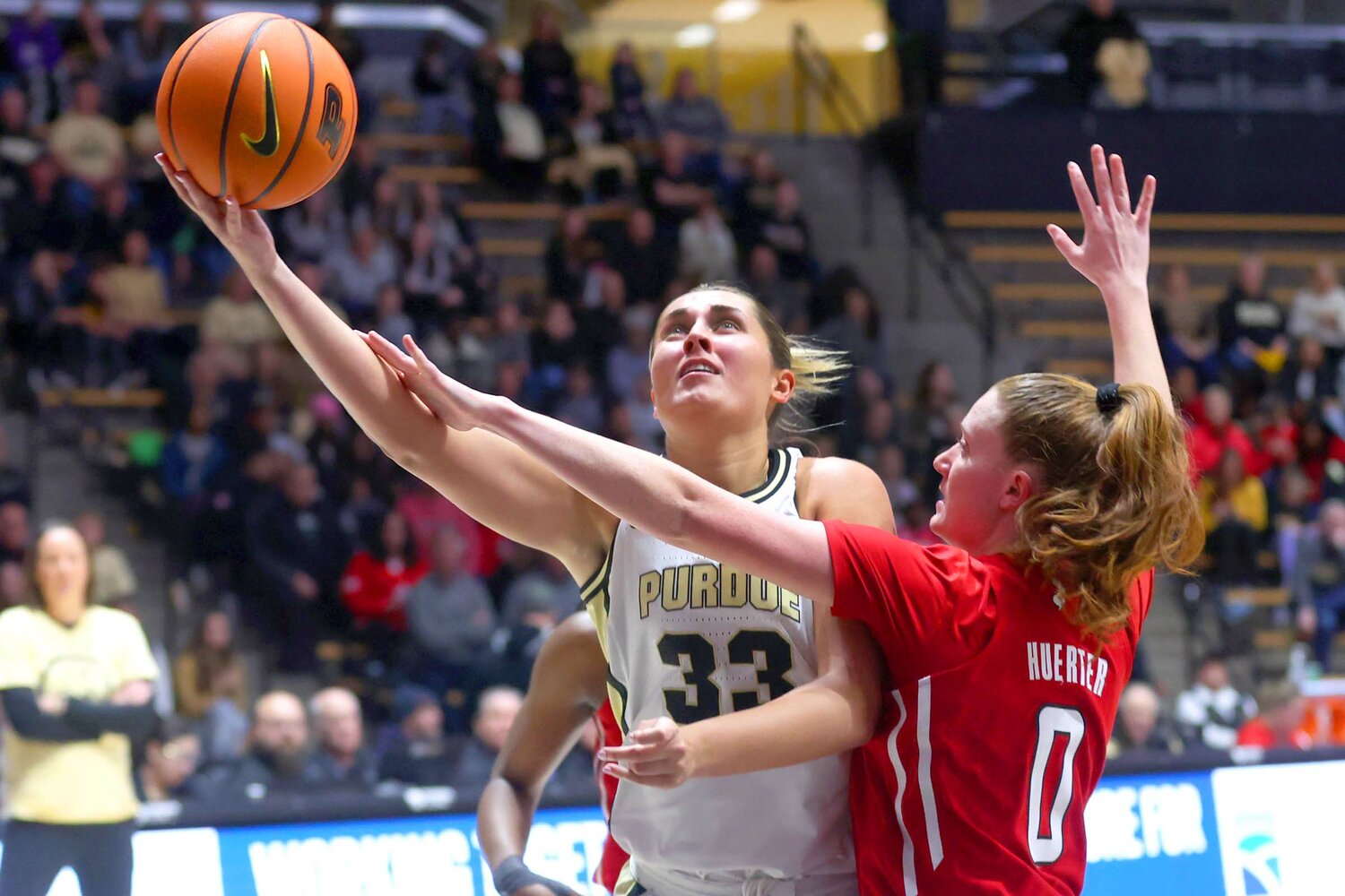 Madison Layden of Purdue - scooping a lay-up against Jillian Huerter of Rutgers