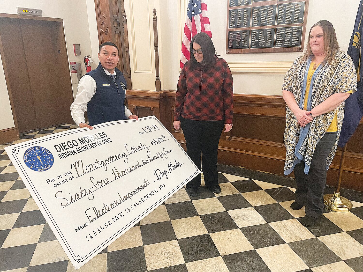 Secretary of State Diego Morales, left, holds a ceremonial check for $64,240 to be awarded to the Montgomery County Clerk’s Office. Accepting the award is election coordinator Cassandra Jett, center, and Montgomery County Clerk Leah Denbo. The funds will be used to purchase election equipment.