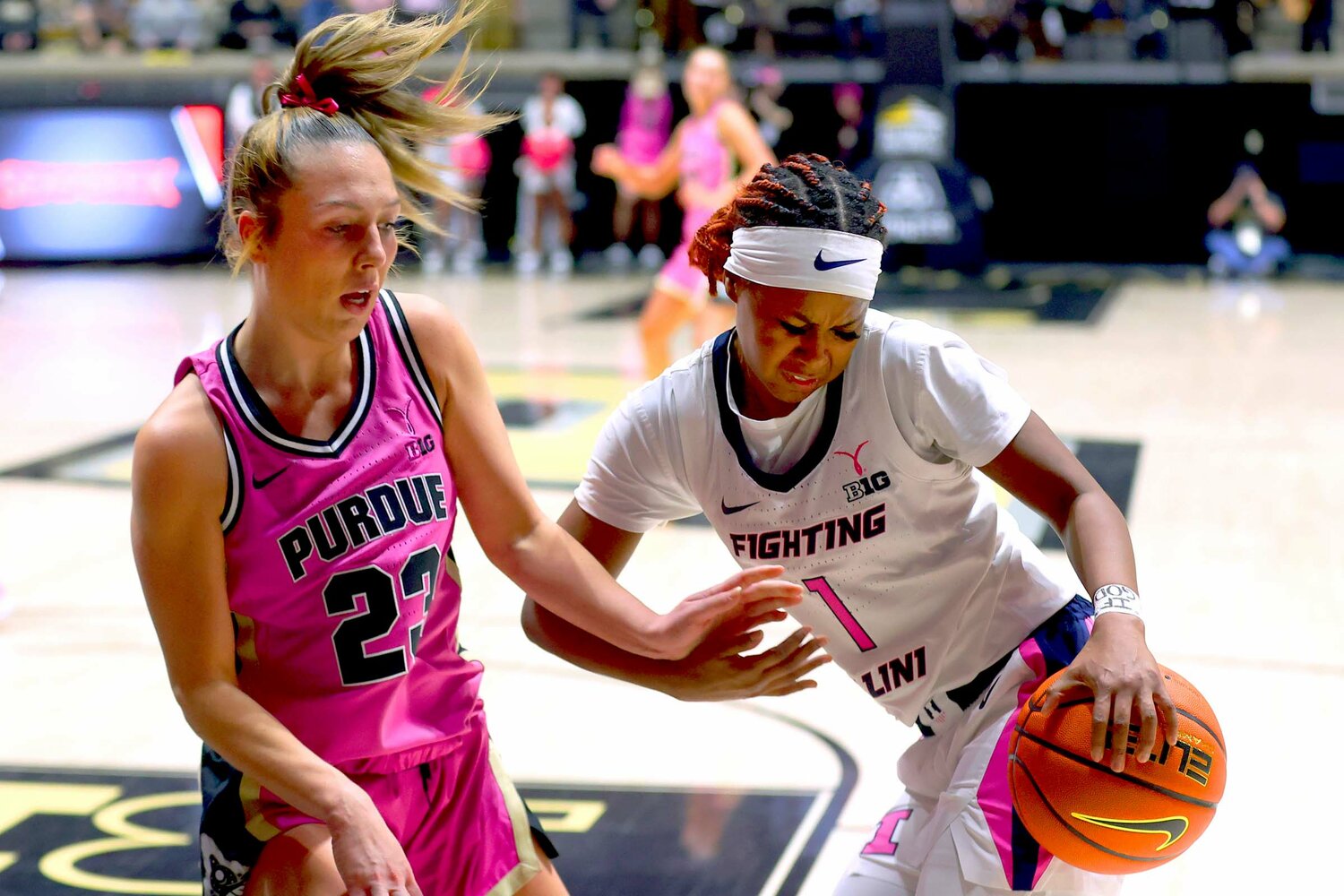 Genesis Bryant of Illinois - trying to dribble away from Abbey Ellis of Purdue