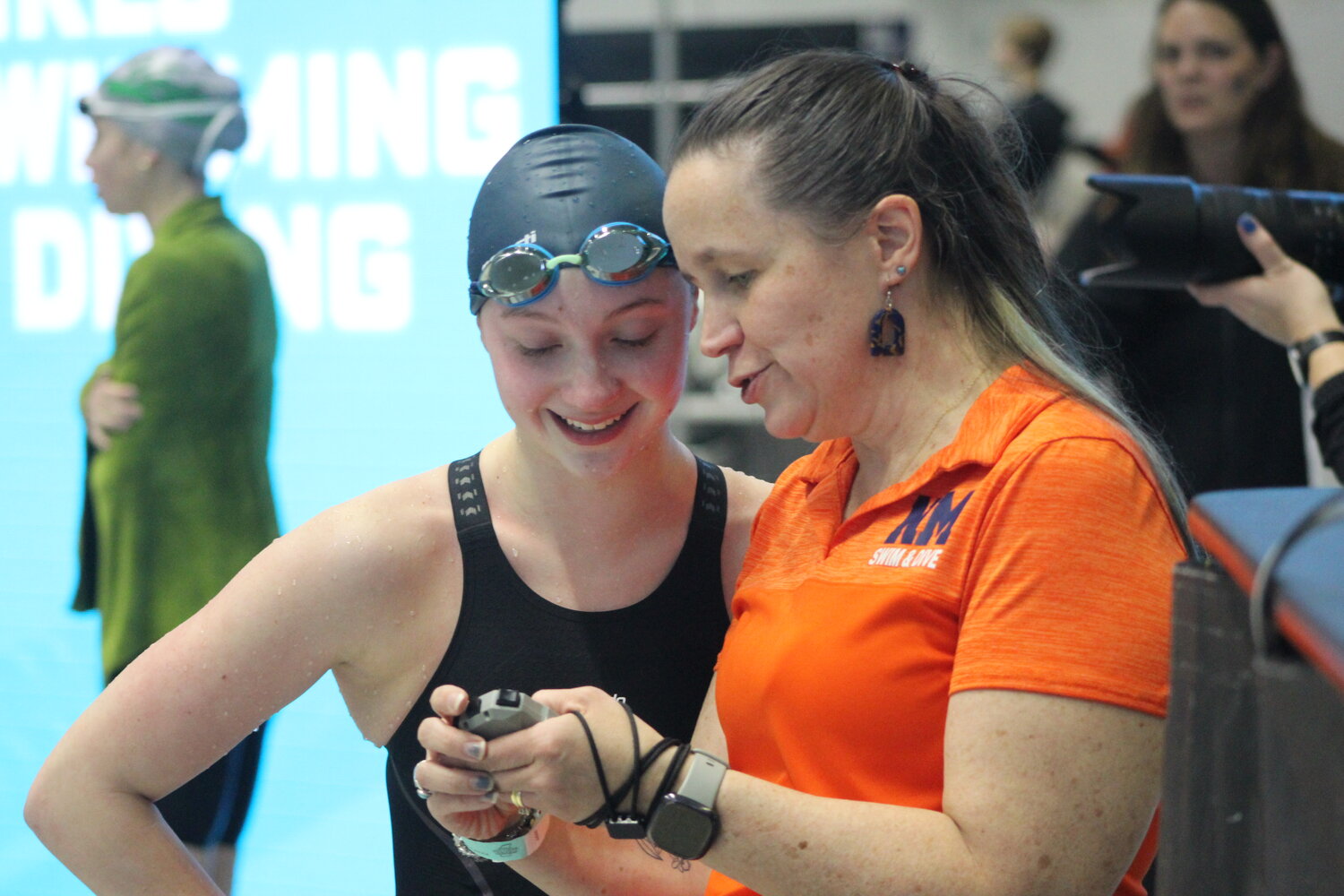 North Montgomery coach Erin Yeager and sophomore Kylie Sankey are both all smiles after Sankey competed in the 200 freestyle.