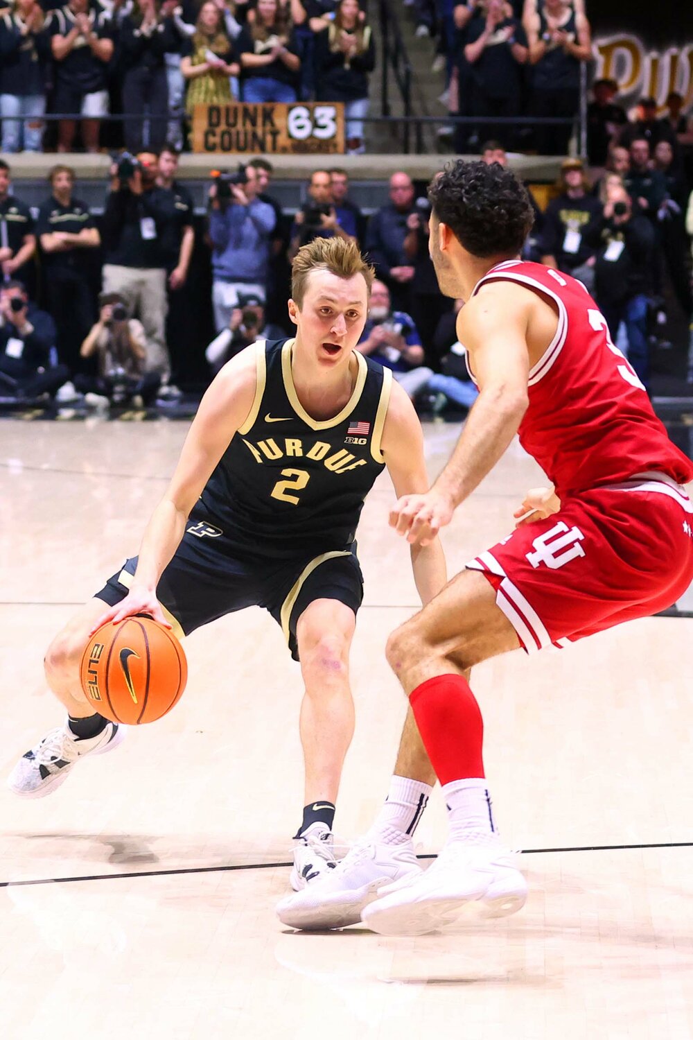 Fletcher Loyer of Purdue - driving against Anthony Leal of Indiana